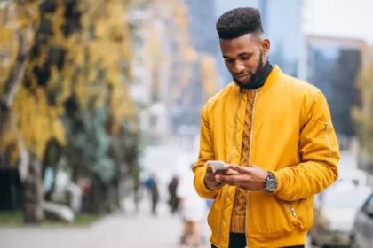 africanamericanstudentwalkingstreettalkingphone